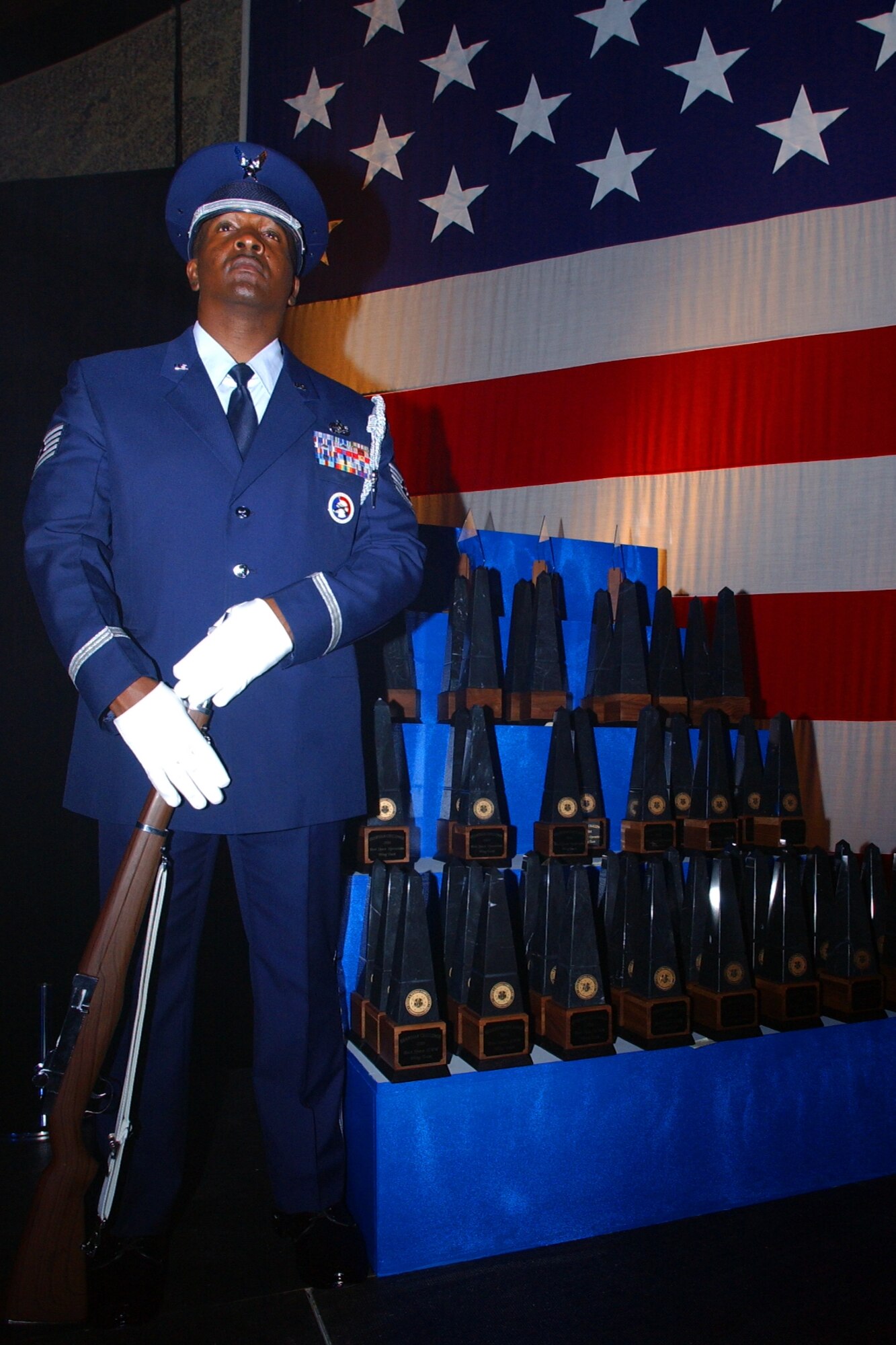 Tech. Sgt. Andrew Fulbright, Front Range Honor Guard ceremonial trainer, stands guard of the Guardian Challenge 2006 trophies, Aug. 17. The 341st Space Wing from Malmstrom Air Force Base, Mont., won the Blanchard Trophy for Best Intercontinental Ballistic Missile Space Wing. The 45th SW from Patrick AFB, Fla., won the Schriever Trophy for Best Space Launch Wing. The 21st SW from Peterson AFB, Colo., won the Aldridge Trophy for Best Space Operations Wing. (Air Force photo by Duncan Wood) 