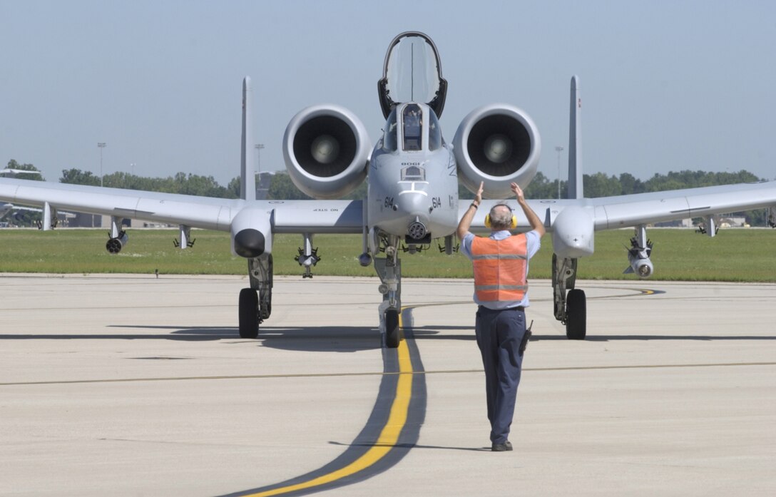 WRIGHT-PATTERSON AIR FORCE BASE, Ohio — Mike Harden, an aircraft service technician with the 88th Mission Support Group, Logistics Readiness Division, Maintenance Section, directs pilot Lt. Col. Chris Bigelow into a parking space on the flight line Tuesday, Aug. 15. The A-10 Thunderbolt II “Warthog” was one of two aircraft from the 104th Fighter Wing, Barnes Air National Guard Base, Westfield, Mass., that flew to Wright-Patterson AFB to promote the 2006 U. S. Air Force Marathon. The close air support aircraft is featured on the logo for this year’s marathon. (Air Force photo by Spencer P. Lane)


