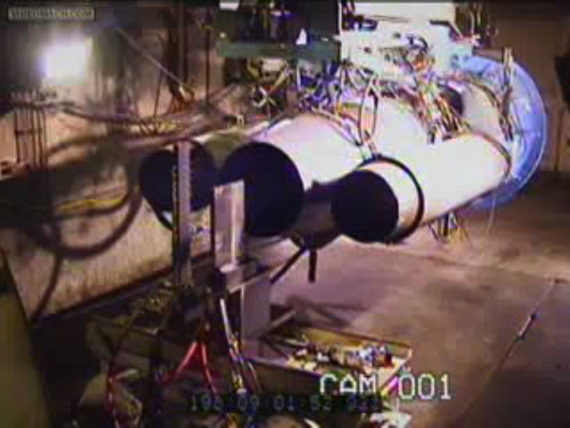 TINKER AIR FORCE BASE, Okla. — The probe rake of AEDC’s continuous sweep emission measurement system, the taller vertical structure to the left, is seen in this video still taken during the alternative fuels testing of the B-52 engine here. (Air Force still from video)  

