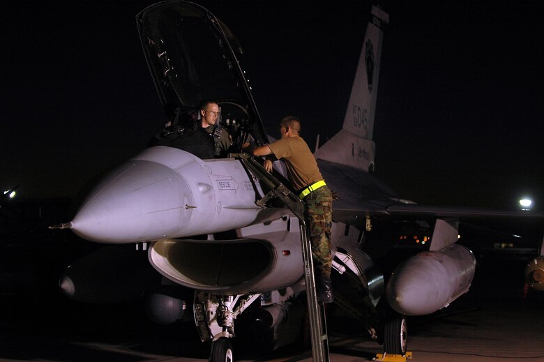 Capt. Jeremy Ryan and Tech. Sgt. Mike Johanns conduct final preflight inspections on an F-16 Fighting Falcon at Red Flag 06-02 at Nellis Air Force Base, Nev., on Aug. 15.   U.S. and coalition servicemembers are participating in the exercise that concludes today. Captain Ryan is a pilot and Sergeant Johanns is a crew chief with the Iowa Air National Guard's 132nd Fighter Wing. (U.S. Air Force photo/Tech. Sgt. Bob Sommer) 