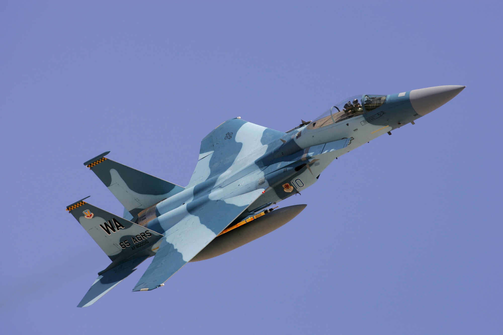 An F-15 with the 65th Aggressor Squadron takes off from Nellis AFB, Nev., Aug. 16. The 65th Aggressor Squadron flies specially camouoflaged F-15s and simulates enemy aircraft and tactics. The 65th is supporting the Red Flag exercise at Nellis through Sept. 2. Red Flag provides advanced combat training for U.S. and Allied aircrews in a highly realistic threat environment. (Photo courtesy Paul Ridgway, Typhire Photography)