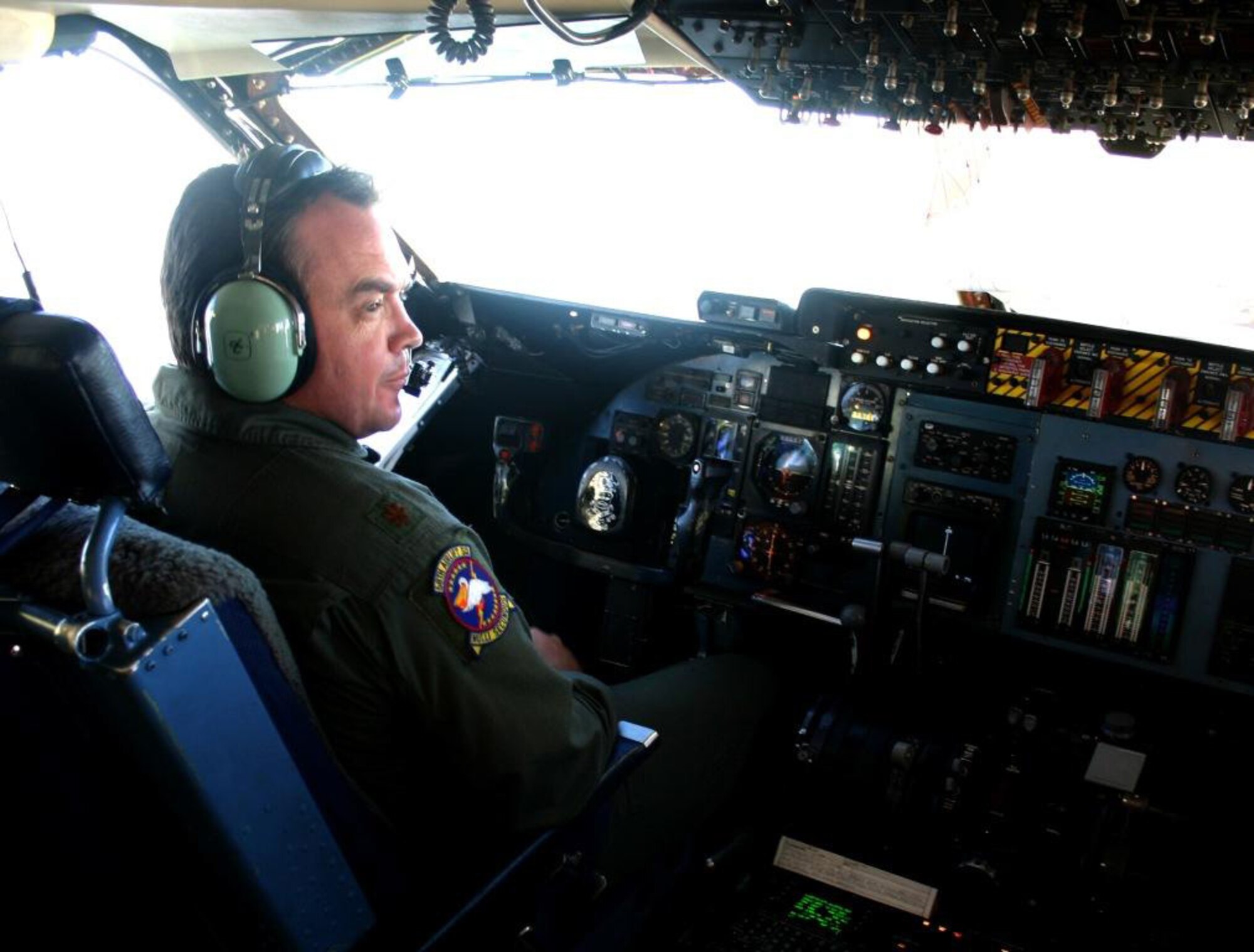 Aircraft commander and pilot, Major Gary Edwards, 68th Airlift Squadron, finds a moment to enjoy the view during on the second leg of the trip from Homestead Air Reserve Base, Fla. to Hickam Air Force Base, Hawaii on Aug. 13. (US Air Force photo by Master Sgt. Ray Sarracino)