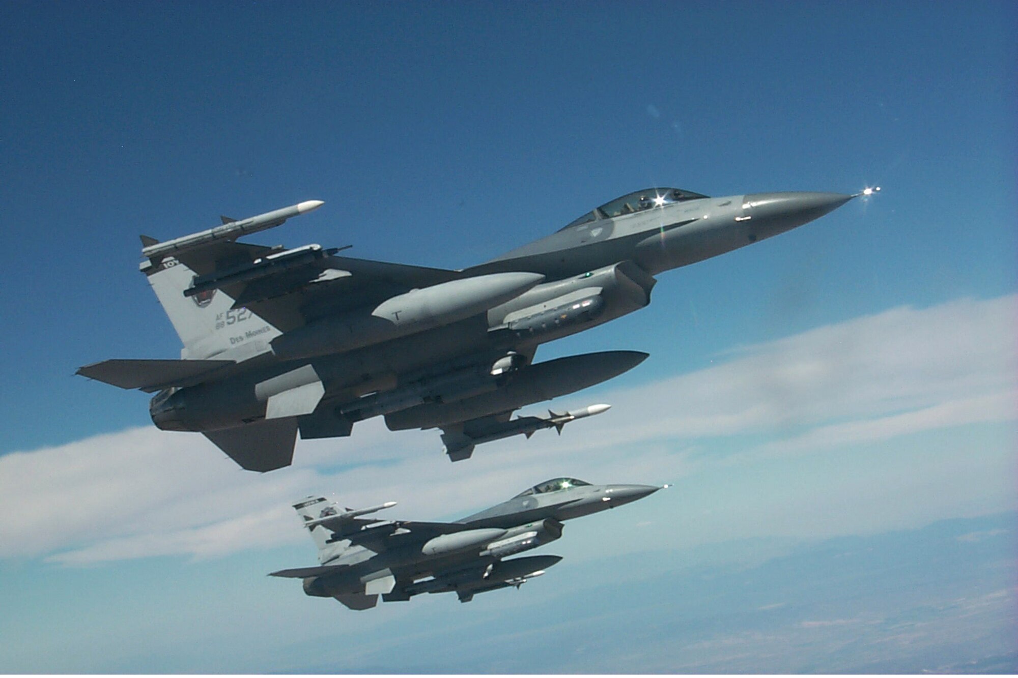 F-16s with the Iowa Air National Guard's 132nd Fighter Wing, 124th Fighter Squadron, fly formation with a KC-135 tanker after taking on fuel during Red Flag exercises at Nellis AFB, Nev., Aug. 17. The 124th is one of more than a dozen units taking part in Red Flag, which puts up to 80 aircraft in the air at one time to sharpen aerial combat skills. (U.S. Air Force photo/Mike Estrada)