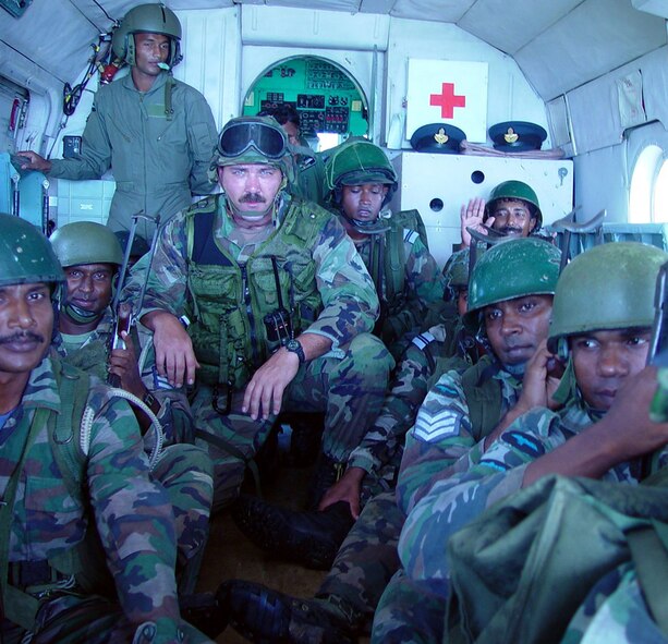 A combat aviation advisor from the 6th Special Operations Squadron rides with members of a host nation during a training mission in the Pacific theater. (Courtesy Photograph)