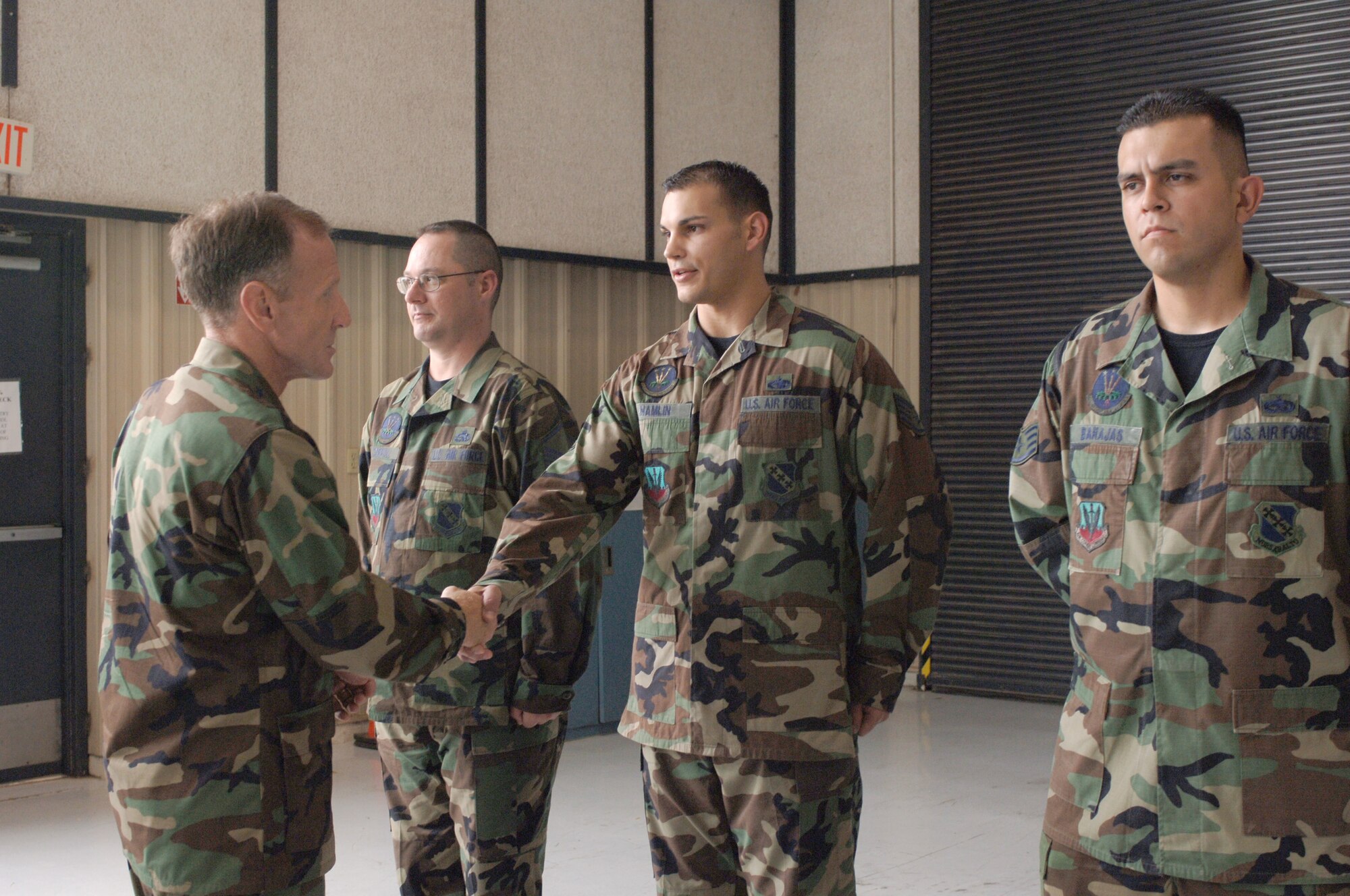 Staff Sgt. Larry Hamlin, 7th Component Maintenance Squadron, and his coworkers, Master Sgt. Mark Carroll (left) and Staff Sgt. Jaime Barajas (right) welcome Lt. Gen. Norman R. Seip, 12th Air Force and Air Forces Southern commander, to Dyess? 7th CMS shop, where the General received a Lean briefing and met many of the maintenance troops.