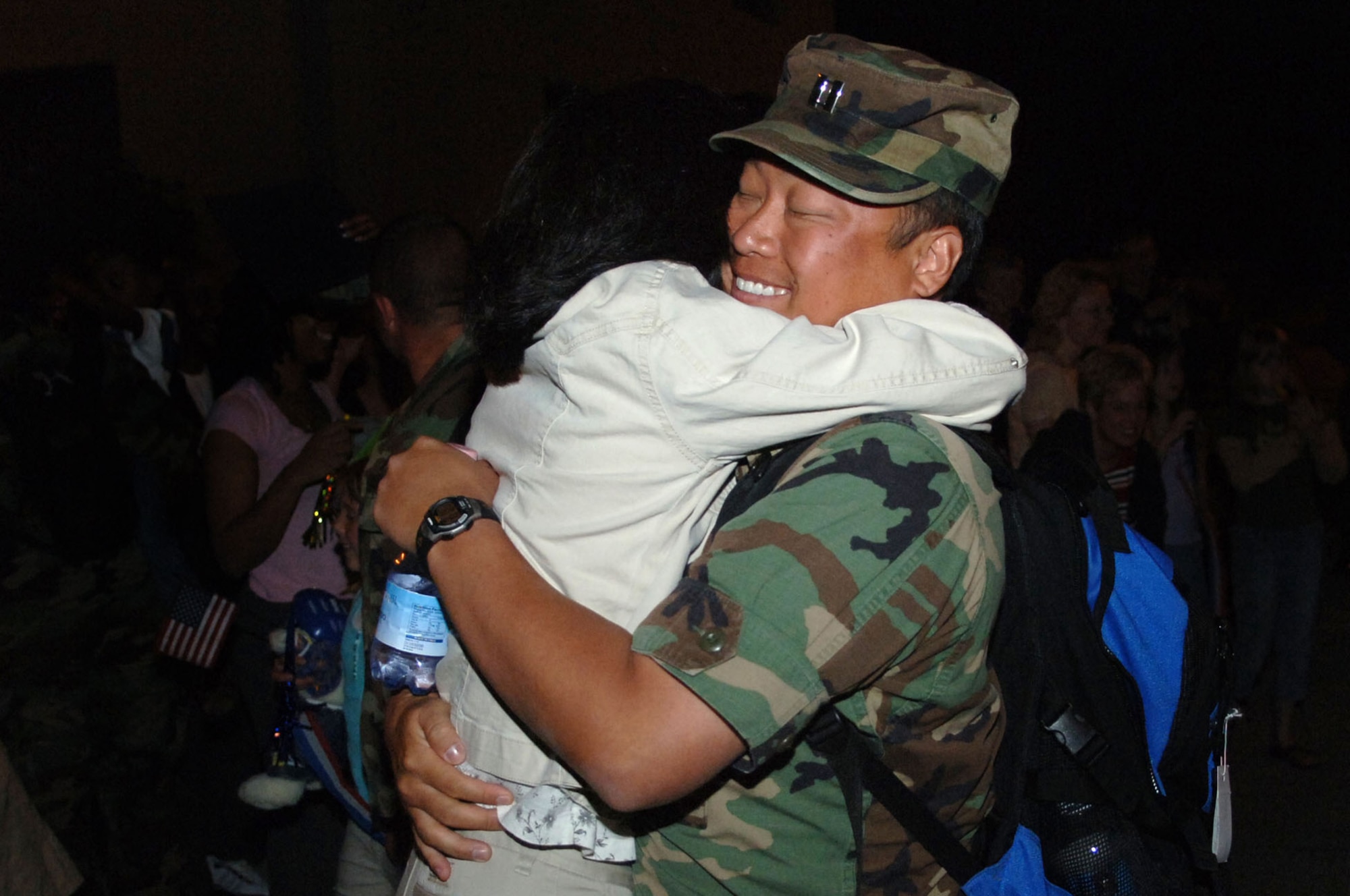 Capt. Chi Suh, a nurse with the 435th Medical Squadron, hugs his wife after returning from a humanitarian mission to Cyprus Aug. 7.