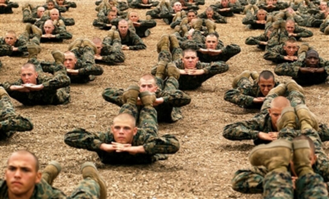 Company C recruits stretch out their abdominal muscles before a martial arts session at the Marine Corps recruit depot in San Diego, Calif., Aug. 18, 2006.   Since August 2005, almost every drill instructor who has graduated from Drill Instructor School here has attended the Instructors’ Course at the depot’s Marine Corps Martial Arts Program facility.
