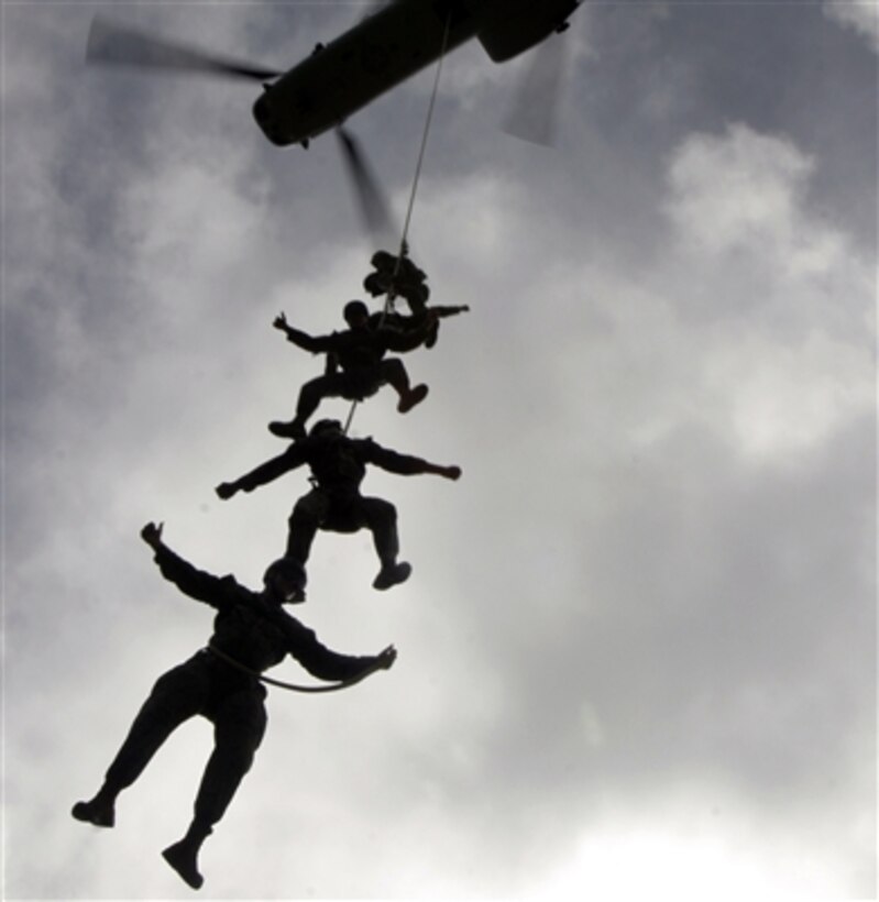 U.S. Marines participate in a Special Patrol Insertion/Extraction exercise as they hang from a 120-foot line attached to a CH-46E Sea Knight helicopter from Marine Medium Helicopter Squadron 265 over Okinawa, Japan,  Aug. 11, 2006. 