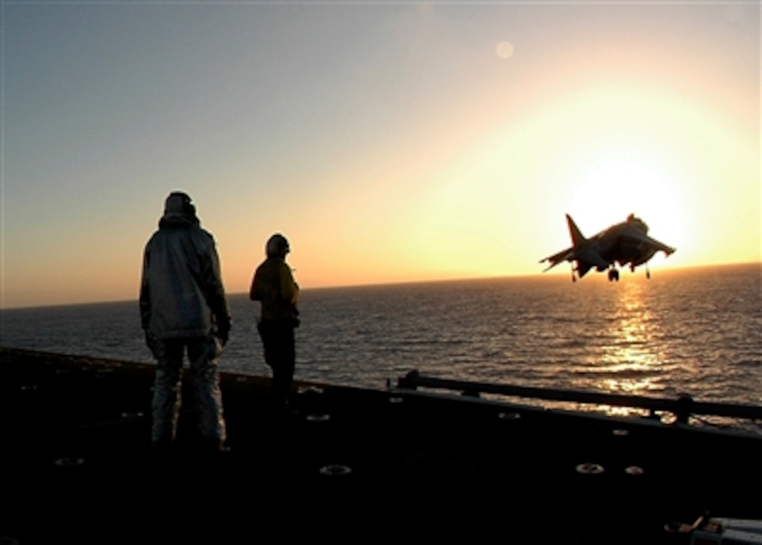 Sailors, onboard the Amphibious assault ship USS Boxer, watch an AV-8B Harrier take off during flight operations in support of their Joint Task Force Exercise in the Pacific Ocean, Aug. 13, 2006.  USS Boxer is part of Expeditionary Strike Group 5, which is currently participating in their Joint Task Force Exercise off the coast of Southern California. 