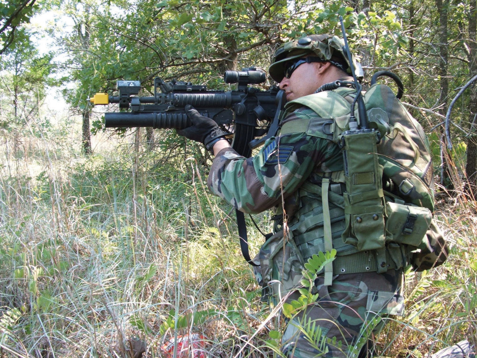 Staff Sgt. David Martinez, 433rd Security Forces Squadron, is carrying the M-4 Weapon System with an M-203 Grenade Launcher attached. He?s sighting in on an enemy position while on  a combat patrol during the recent Patriot Defender excercise at Camp Swift, near Bastrop, Texas. (U.S. Air Force photo/Tech. Sgt. Stacey Kruse)
