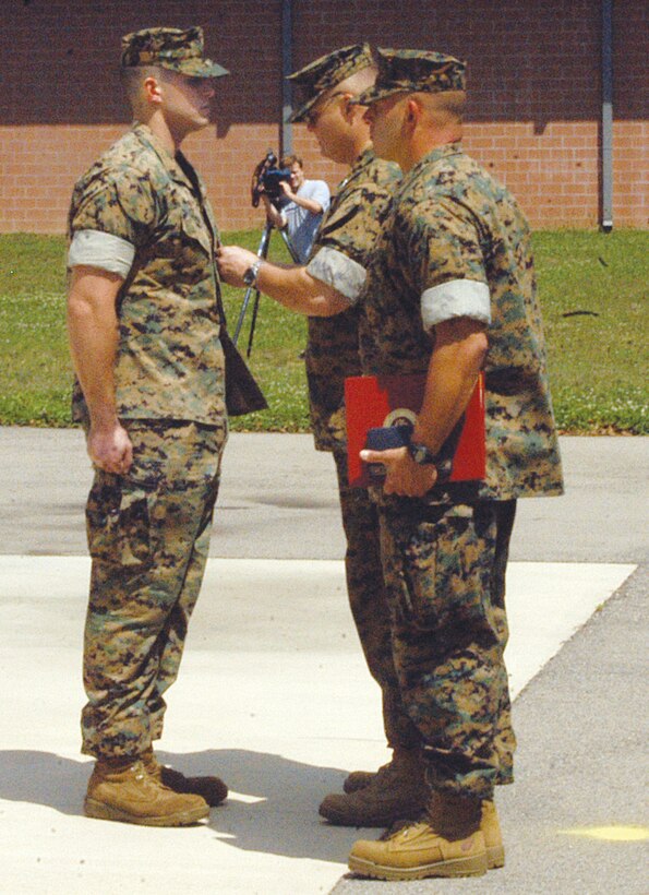 COLUMBUS, Ohio - Cpl. Mark A. Camp, an automatic rifleman with Lima Company, 3rd Battalion, 25th Marine Regiment, receives the Silver Star Medal at a ceremony here Aug. 20. (Official U. S. Marine Corps photo by Pfc. Mary A. Staes)