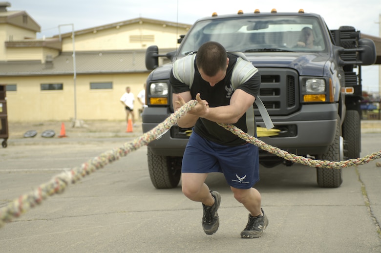 FAIRCHILD AIR FORCE BASE, Wash. -- U.S. Air Force Airman 1st Class Justin Reiter of Puyallup, Wash., Survival, Evasion, Resistance and Escape (SERE) Specialist, pulls a pick-up truck 40 feet during the first ever SERE Challenge held here on Aug. 10, 2006.   Twenty-three members of the 336th Training Group participated in the challenge which included an obstacle course, 3-mile run, 6-mile road march, and a variety of other events that tested the strength and stamina of participating members. (U.S. Air Force Photo/Tech. Sgt. Laura K. Smith)