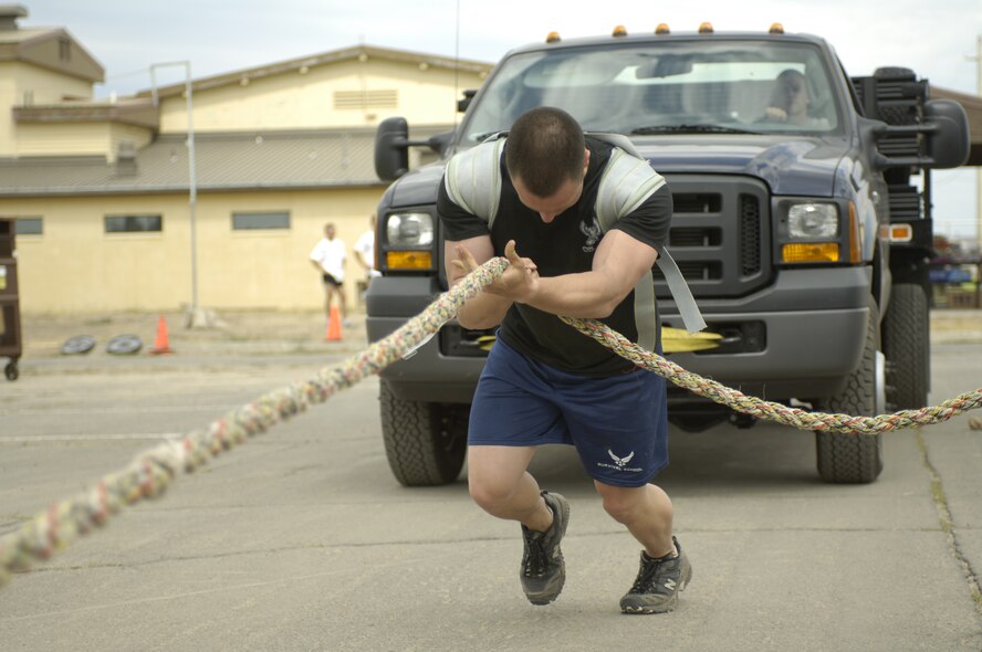 FAIRCHILD AIR FORCE BASE, Wash. -- Airman 1st Class Justin Reiter of Puyallup, Wash., Survival, Evasion, Resistance and Escape Specialist, pulls a pick-up truck 40 feet during the first ever SERE Challenge held here on Aug. 10, 2006. Twenty-three members of the 336th Training Group participated in the challenge which included an obstacle course, 3-mile run, 6-mile road march, and a variety of other events that tested the strength and stamina of participating members. (U.S. Air Force Photo/Tech. Sgt. Laura K. Smith)