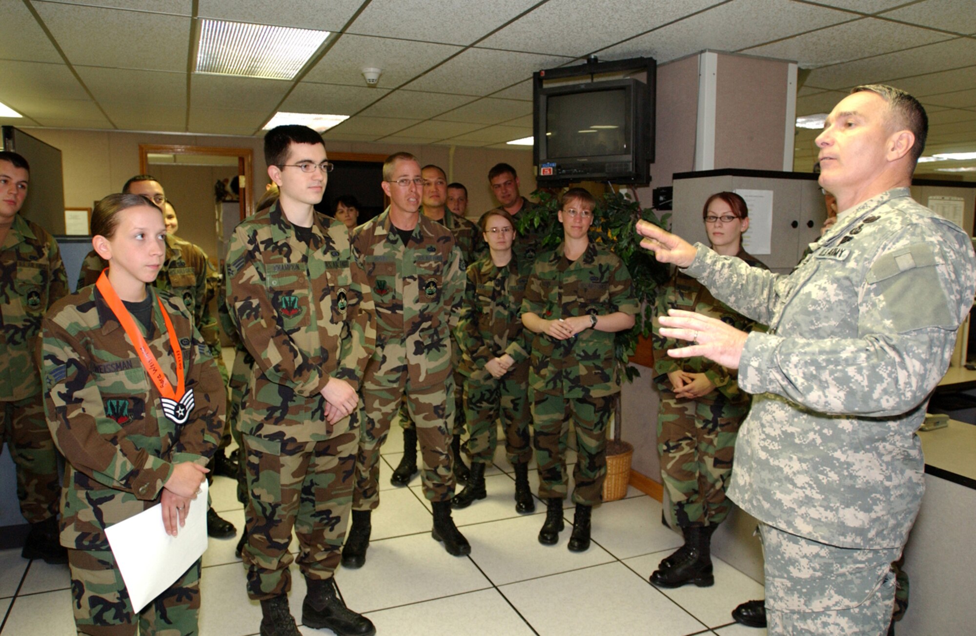 ELMENDORF AIR FORCE BASE, Alaska -- Command Sergeant Major William J. Gainey, Senior Enlisted Advisor to the Chairman, Joint Chiefs of Staff, speaks with members of the 381st Intelligence Squadron. Senior Airman Sara Weissman displays her staff sergeant stripes after having been notified that morning of her promotion. The sergeant major was visiting servicemembers stationed in Alaska as part of his duties as the first SEAC.    
USAF photo by Staff Sgt. David Donovan                                                        