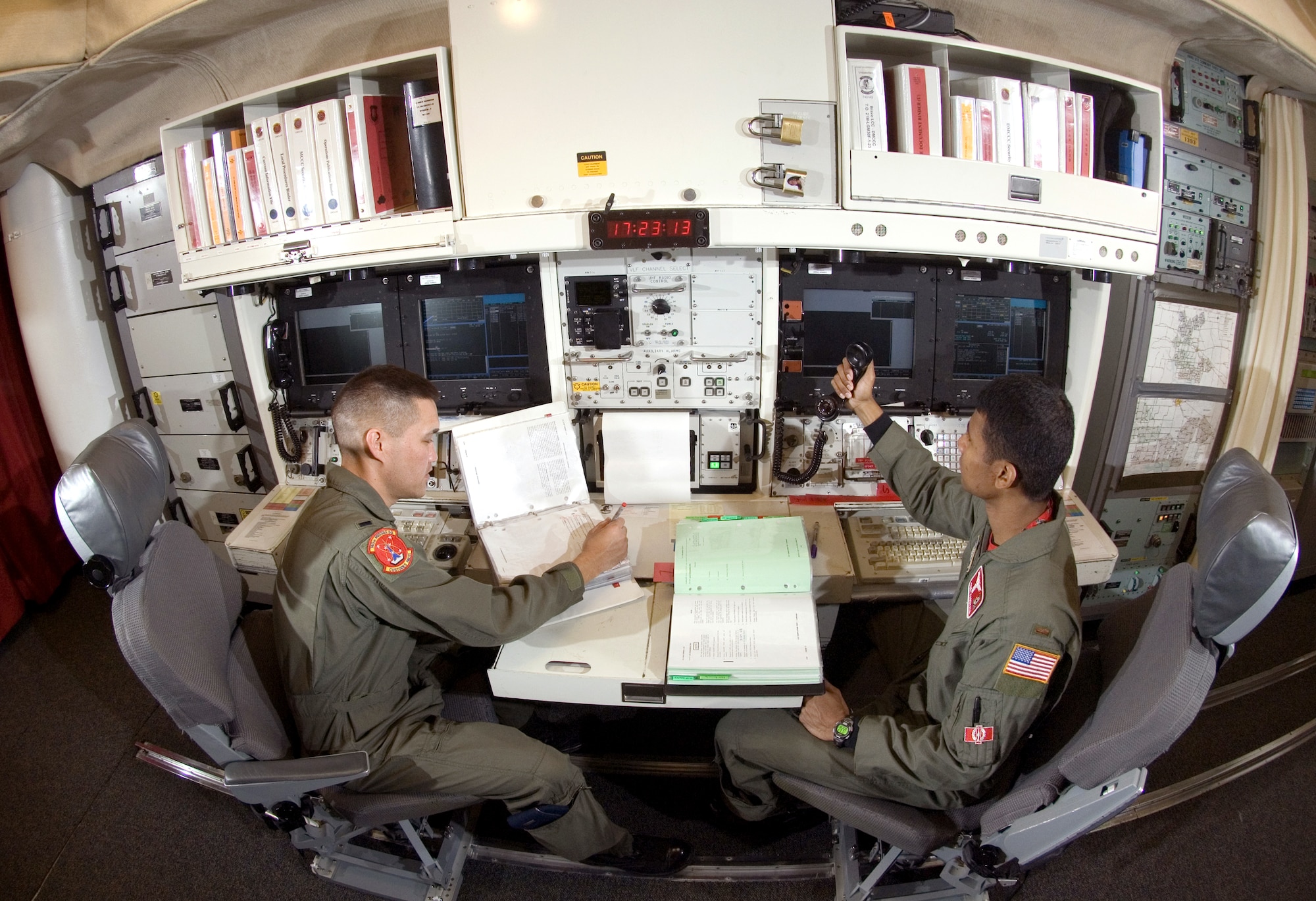 In the underground launch control center at Minot Air Force Base's Missile Alert Facility B-1, one of 15 91st Space Wing MAFs scattered across northwest North Dakota, 1st Lt. John Manibusan (left) and 2nd Lt. Trey Marshall are on duty Aug. 18.  The missile combat crew will be on duty for 24 hours, able to monitor and launch Minuteman III missiles if directed. The officers are with the 740th Missile Squadron.  (U.S. Air Force photo/Master Sgt. Lance Cheung) 