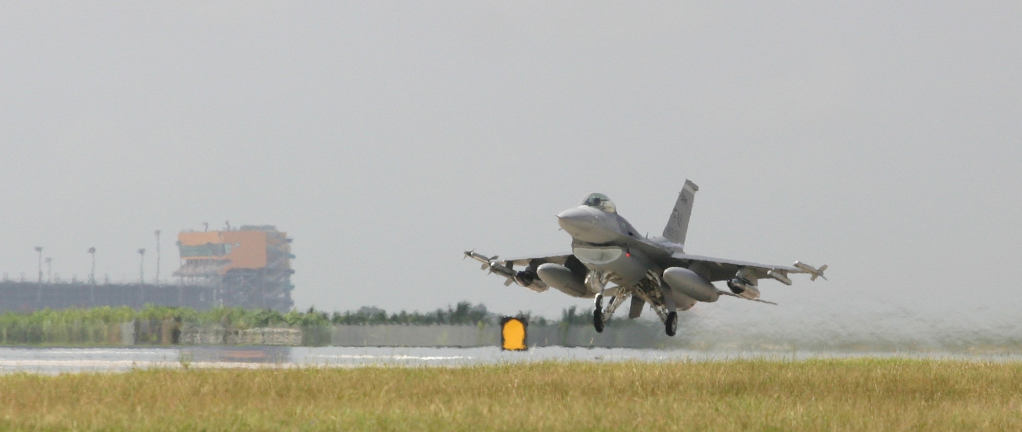 A 482nd Fighter Wing F-16 lifts off Aug. 11 here at Homestead Air Reserve Base, Fla. on its way to Hickam Air Force Base, Hawaii. Homestead reservists headed to Hickam AFB to train with the Hawaii Air National Guard in exercise Cactus Aloha. (US Air Force photo by Tech. Sgt. Bucky Parrish)