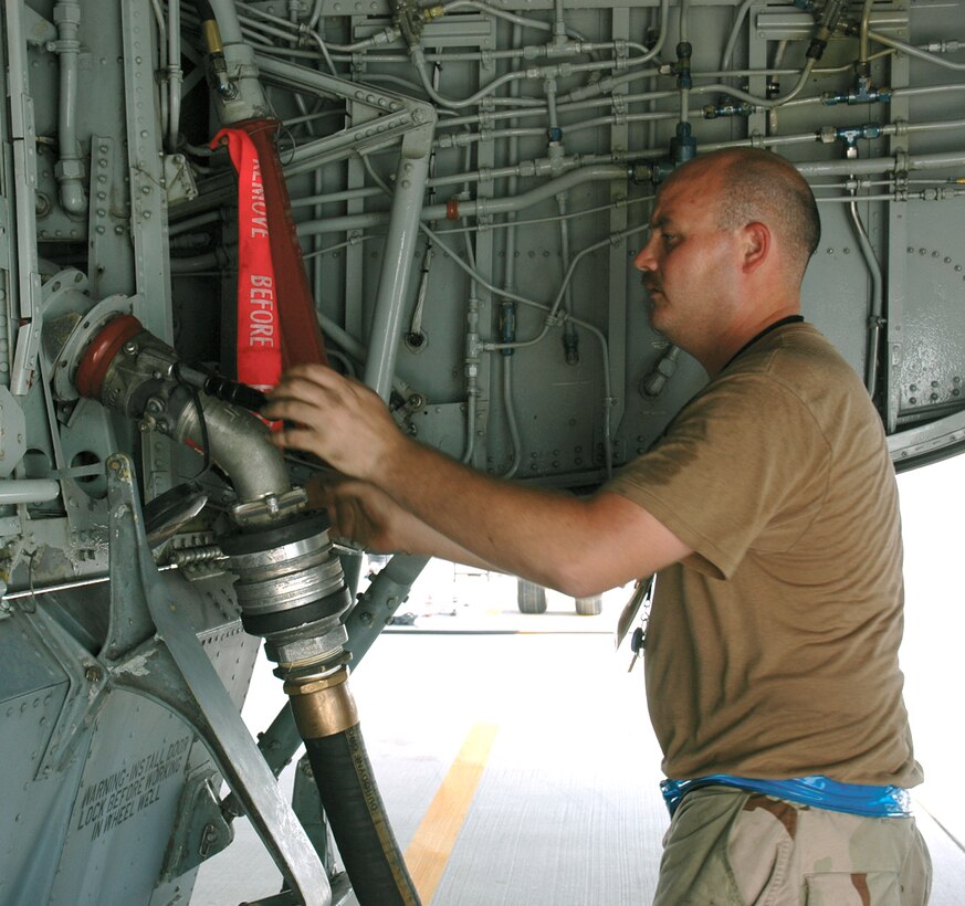 Staff Sgt. Marcus Franklin connects the refueling hose to a KC-135 Stratotanker at a forward operating base in Southwest Asia. Sergeant Franklin is a crew chief deployed to the 340th Aircraft Maintenance Unit from MacDill Air Force Base, Fla. (U.S. Air Force photo/Staff Sgt. Celena Wilson)