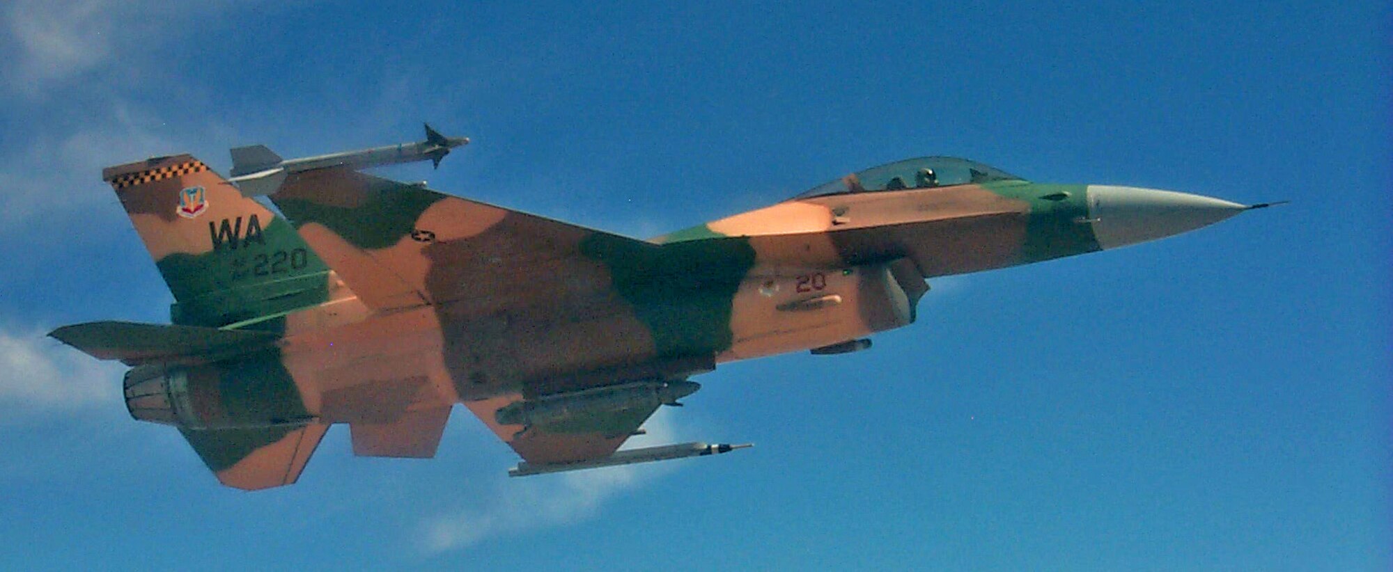 An F-16 Fighting Falcon of the 64th Aggresor Squadron, Nellis AFB, Nev., waits for the rest of the flight to complete refueling before joining the fight in the Red Flag exercise which continues through Sept. 2. Red Flag puts 80 or more aircraft in the air at one time to fine-tune crew training during highly realistic combat operations over the 15,000-square-mile Nevada Test and Training Range Complex. (U. S. Air Force photo/Mike Estrada)