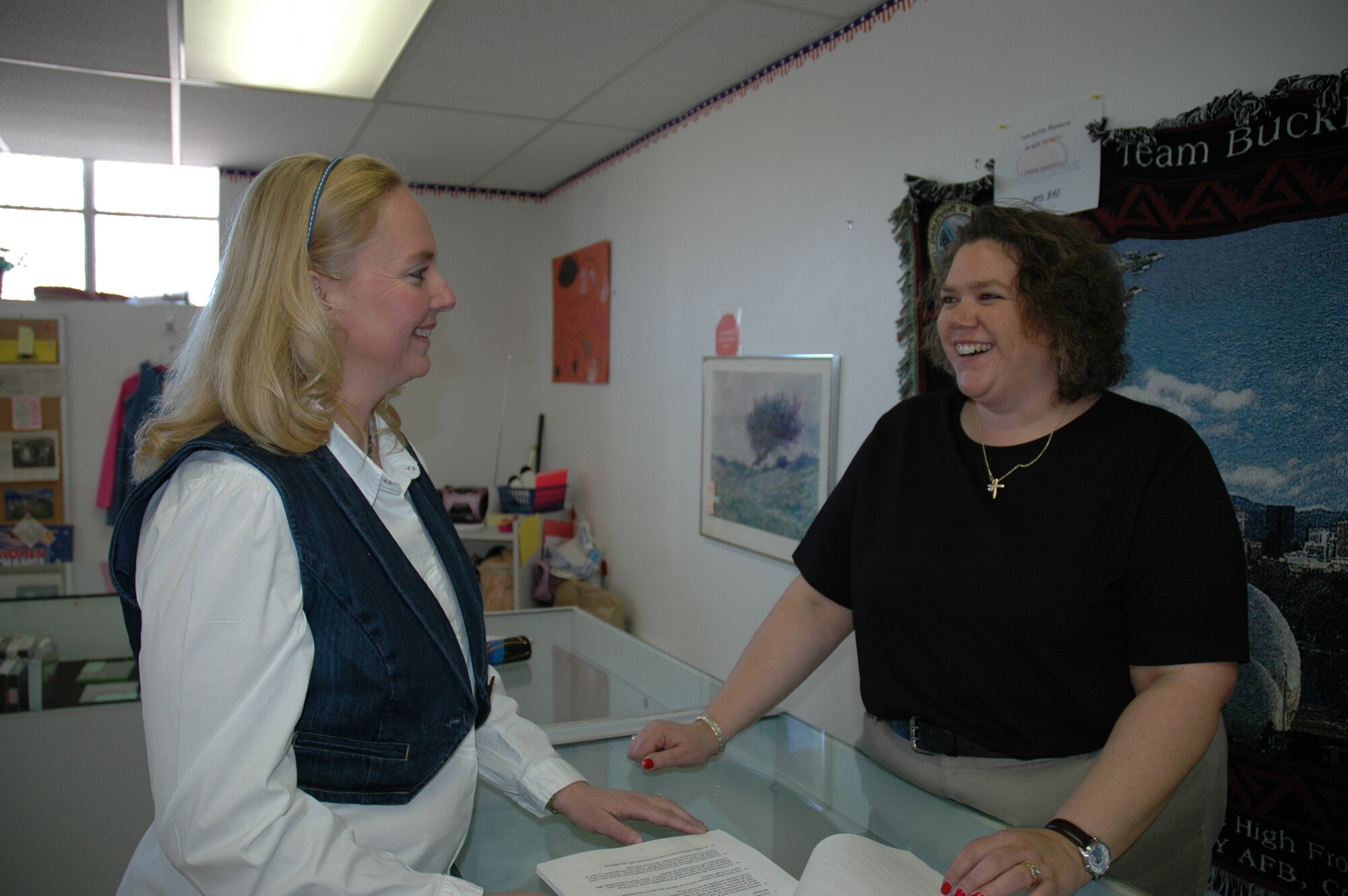 Mrs. Meredith Muhs, above left, stops in to visit and share a laugh with the new manager at the Buckley Thrift Shop, Mrs. Diane Herrlman.  Mrs. Muhs was named Buckley Air Force Base Spouse of the Year, then Air Force Space Command Spouse of the Year, and will now compete at the Air Force level for the same honor. (U.S. Air Force photo by Mrs. Barbara Atwell)