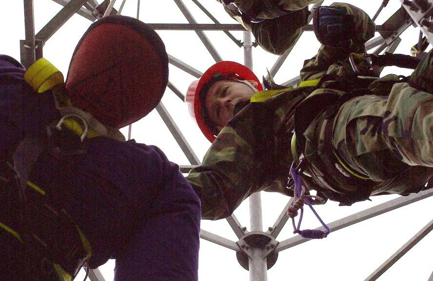 Tech. Sgt. Jason Miller, 1st Communications Maintenance Squadron, Kapaun Air Base, Germany, hoists a dummy in preparation for tower-rescue training.The 1st CMXS instructors provided the training to 10 Airmen from the 488th Intelligence Squadron Aug. 1 through 3. (U.S. Air Force photo by Senior Airman Clark Staehle)