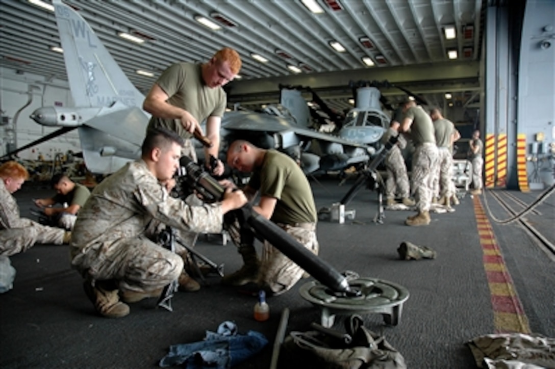 U.S. Marines perform maintenance on their equipment in the hangar bay of the USS Boxer (LHD 4) as the ship operates in the Pacific Ocean on Aug. 15, 2006.   The Marines are part of Weapons Company, 2nd Battalion, 4th Marines, attached to the 15th Marine Expeditionary Unit.  