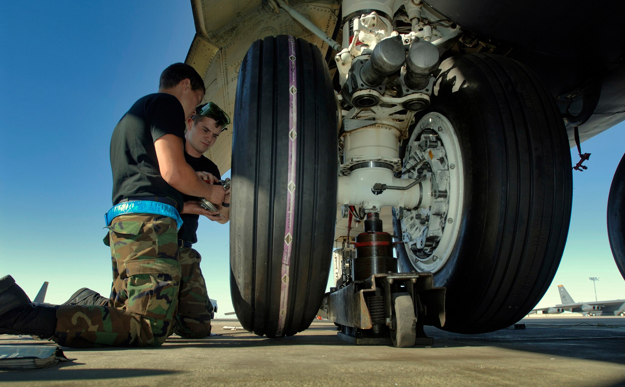 Airman Eric Andreasen (left) and Senior Airman Michael Schaff change a tire on a B-52 Stratofortress at Minot Air Force Base, N.D., Aug. 21. The Airmen are from the 5th Aircraft Maintenance Squadron at Minot AFB. (U.S. Air Force photo/Master Sgt. Lance Cheung) 
