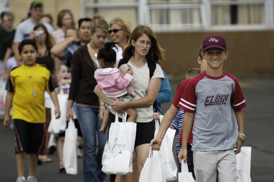 FAIRCHILD AIR FORCE BASE, Wash. -- Participants walk to a KC-135 Stratotanker as part of the wing's Family Mobility Day activities Aug. 10.  The event is designed to give family members insight to the experience of deploying Airmen and the services offered to the families who continue the mission at home once the servicemember has deployed. (U.S. Air Force photo/ Senior Airman Anthony Ennamorato)