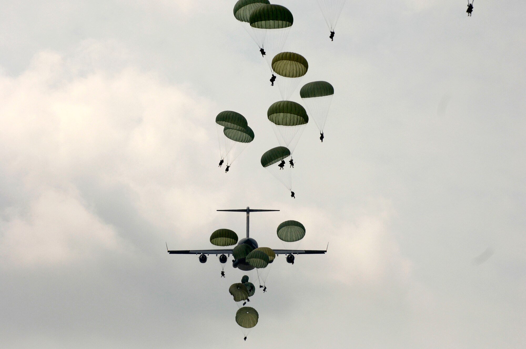 Army Soldiers jump out of a C-17 Globemaster III Aug. 21 during a joint forcible entry exercise with the Air Force over the East Coast. The JFEX training exercise is designed to validate combat readiness, leadership, planning staff, aircrews and ground forces in joint airborne warfighting capabilities through integrated scenario-based training operations. The Soldiers are with the 20th Engineer Battalion at Fort Bragg, N.C. (U.S. Air Force photo/Tech. Sgt. Denise Rayder)
