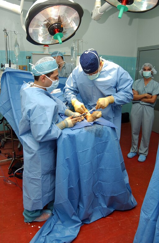 Dr. Aristides Castillo and Capt. (Dr.) Charles Haggerty repair the tibia of a 6-year-old Honduran boy who was hit by a taxi cab during surgery Aug. 15 at the Hospital Esquela in Tegucigalpa, Honduras. The procedure was accomplished as part of a pediatric orthopedic medical readiness training exercise. A medical team of eight people from Wilford Hall Medical Center at San Antonio and Joint Task Force-Bravo at Soto Cano Air Base, Honduras, treated more than 200 people and operated on more than 60 individuals during its two-week training exercise Aug. 5 to 19. Dr. Castillo is a Honduran resident at Hospital Esquela and Captain Haggerty is a resident at Wilford Hall. (U.S. Air Force photo/Senior Airman Mike Meares)
