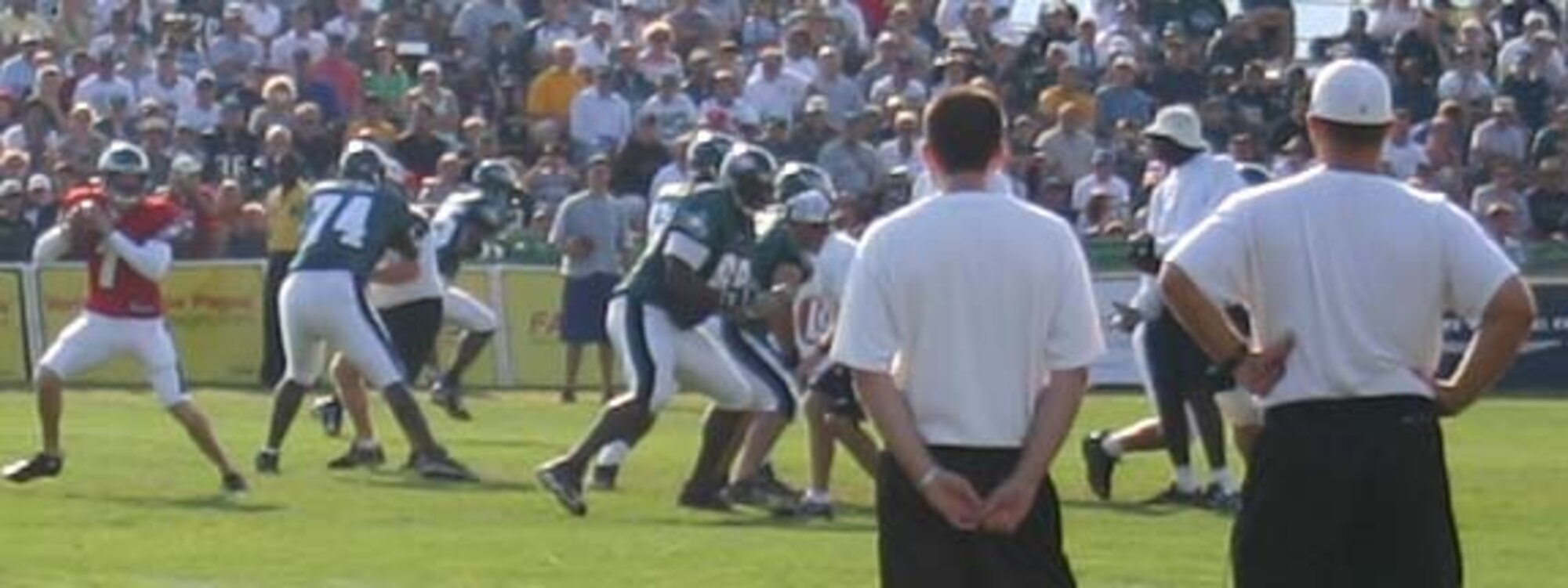 Members of the Philadelphia Eagles practice their skills in preparation for this year’s football season. The  team offered attending servicemembers an opportunity to join them on the field after their practice. The football players and coach signed autographs and had their photos taken with the servicemembers.
