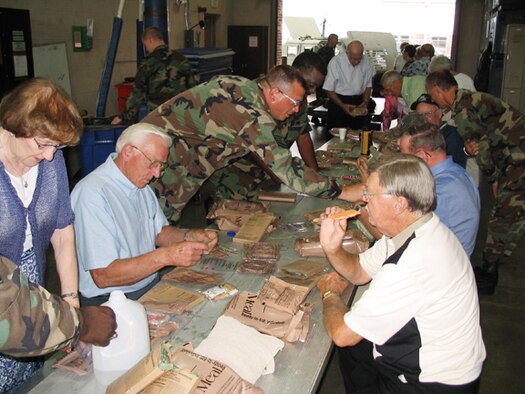 GRISSOM AIR RESERVE BASE, Ind -- Members of the Grissom Community Council get a taste of military life as they eat MREs during a general membership meeting hosted by the 434th Security Forces Squadron.  The GCC is a non-profit civilian organization consisting of business leaders from the North Central Indiana area and provides support to Grissom ARB.  (U.S. Air Force photo/Senior Master Sgt. Brad Klepinger)