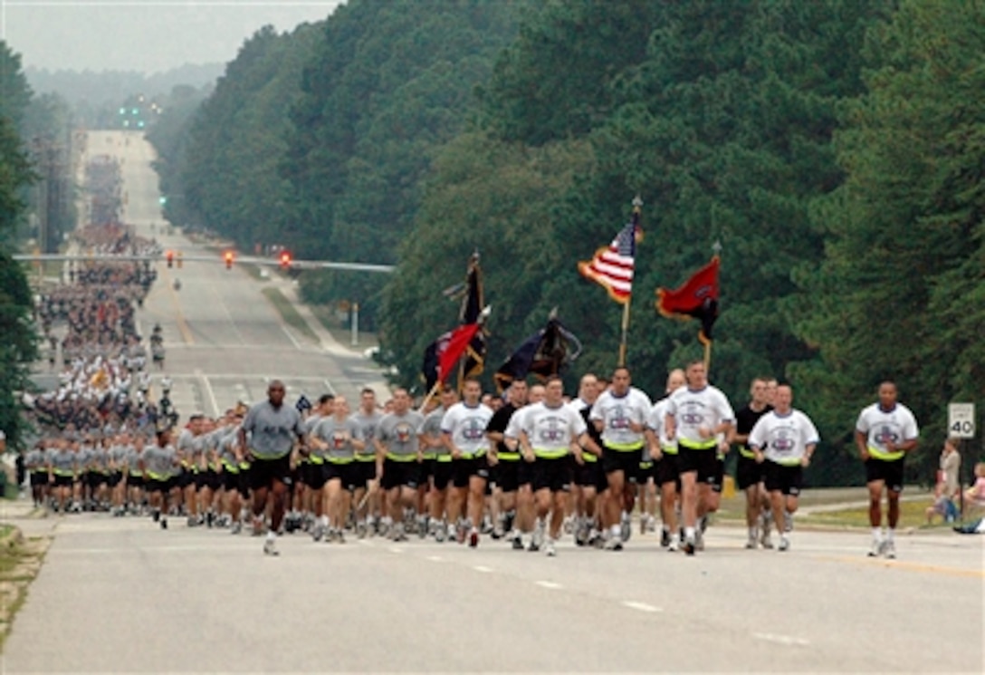 U.S. Army Maj. Gen. David Rodriguez, commander of 82nd Airborne Division, and Command Sgt. Maj. Thomas Capel lead soldiers of the 82nd Airborne on a four-mile run to celebrate its 89th birthday down Longstreet Road at Fort Bragg, N.C., Aug. 18, 2006. 