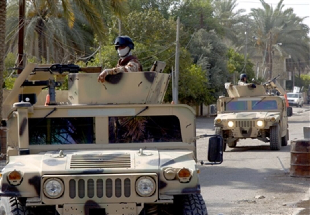 Iraqi army soldiers move into a neighborhood to set up road blocks in Baghdad, Iraq, Aug. 13, 2006.