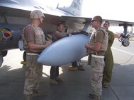 Capt. Nick Edwards, pilot with the 421st, fills out his post-flight forms documentation after Aircraft 87-0428 flew over 6,000 hours. Staff Sgt. Jason Butts, Staff Sgt. Charlie Martin, and Senior Airman James Fairbanks look on before they begin post-flight maintenance.	 