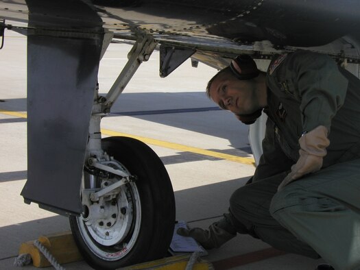 Instructor Pilot 1st Lt. Philip McClure performs a pre-flight inspection prior to his training sortie. (U.S. Air Force photo by Capt. Tony Wickman)