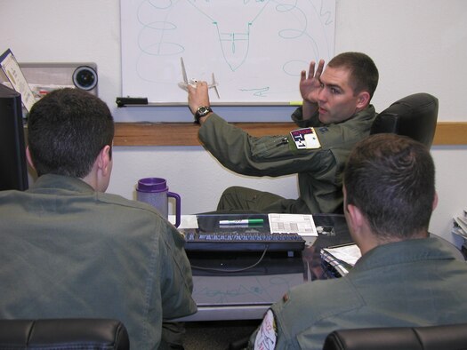 Part of Capt. Eric Westby's job as L-Flight commander in the 32nd Flying Training Squadron is to fly as an instructor pilot with Joint Specialized Undergraduate Pilot Training students. Here he demonstrates aerial refueling techniques using a T-1A model and dry erase board. (U.S. Air Force photo by Capt. Tony Wickman)