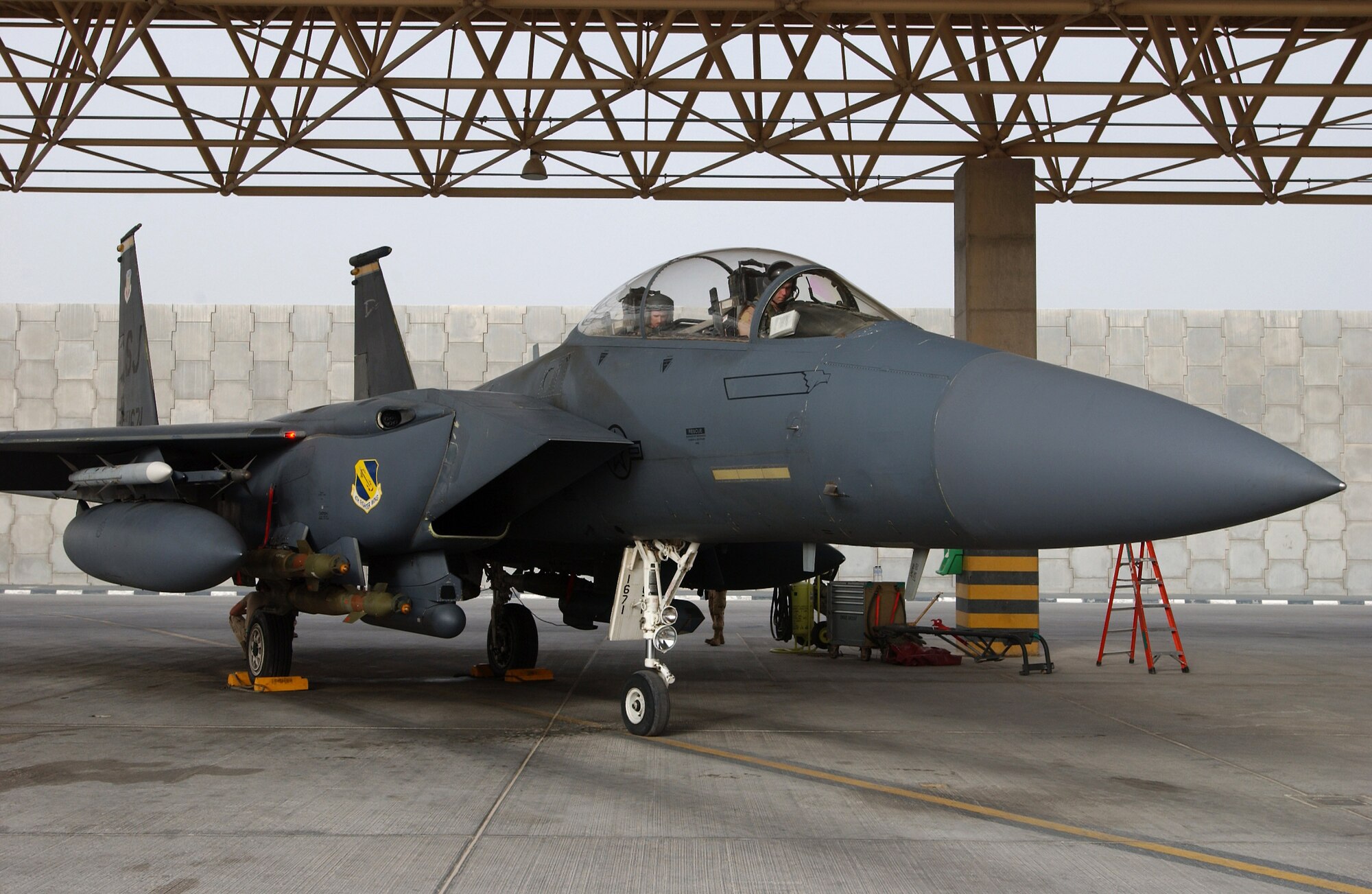 Maj. Jeff O'Donnell and 1st Lt. Nathan Rivinius stand by in their F-15E Strike Eagle and wait for the chocks to be pulled before a combat mission from a forward operating base in Southwest Asia Aug. 18. Major O'Donnell is a pilot and Lieutenant Rivinius is a weapons systems officer. They are deployed to the 335th Expeditionary Fighter Squadron from Seymour Johnson Air Force Base, N.C. (U.S. Air Force photo/Master Sgt. John DeGroot) 