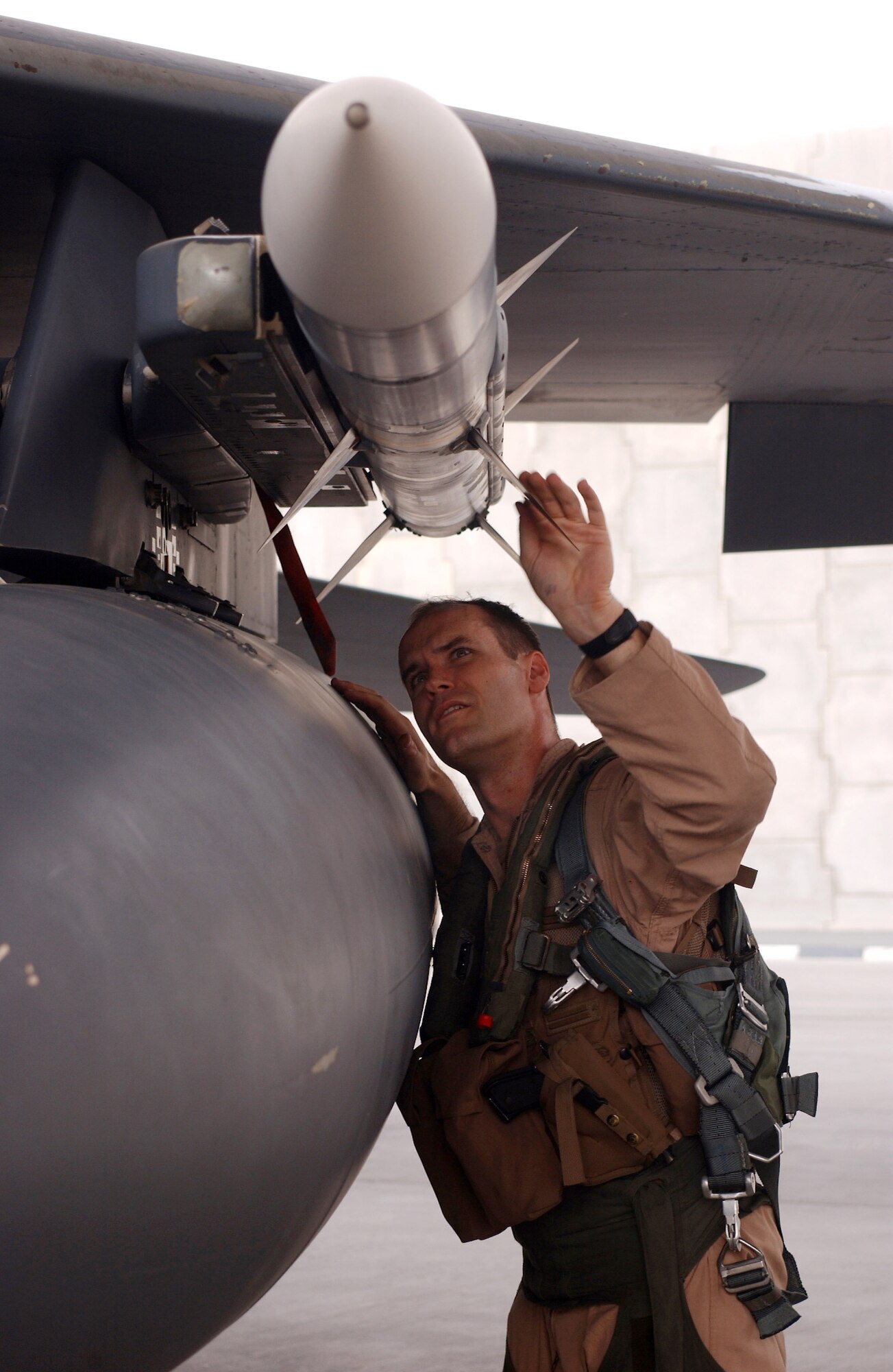 Maj. Jeff O'Donnell checks an AIM-120 air-to-air missile during the pre-flight inspection of his F-15E Strike Eagle before a combat mission from a forward operating base in Southwest Asia Aug. 18. Major O'Donnell is a pilot deployed to the 335th Expeditionary Fighter Squadron from Seymour Johnson Air Force Base, N.C. (U.S. Air Force photo/Master Sgt. John DeGroot)