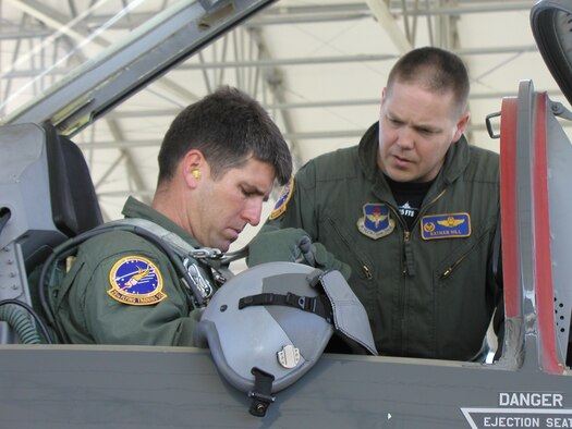 Lt. Col. Nathan Hill, 25 Flying Training Squadron commander, prepares his "honorary commander," Mr. Brian Henson of Henson Construction, to take a flight in a T-38C Talon aircraft. Part of the squadron commander's responsibility is maintaining and facilitating off-base community relations contacts. One way to do that is to have an honorary commander and orientate him or her to the mission of the unit, the wing and the Air Force. (U.S. Air Force photo by Capt. Tony Wickman)
