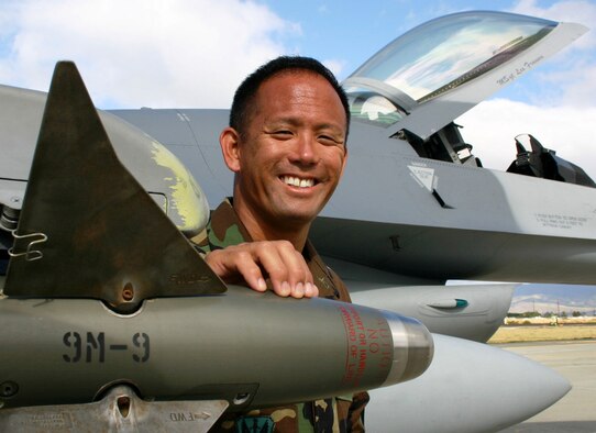 Master Sgt. John Kawachika proudly displays the fruits of his labors, a properly mounted air-to-air missile, during exercise Cactus Aloha at Hickam Air Force Base, Hawaii, August 17. (US Air Force photo by Master Sgt. Ray Sarracino)