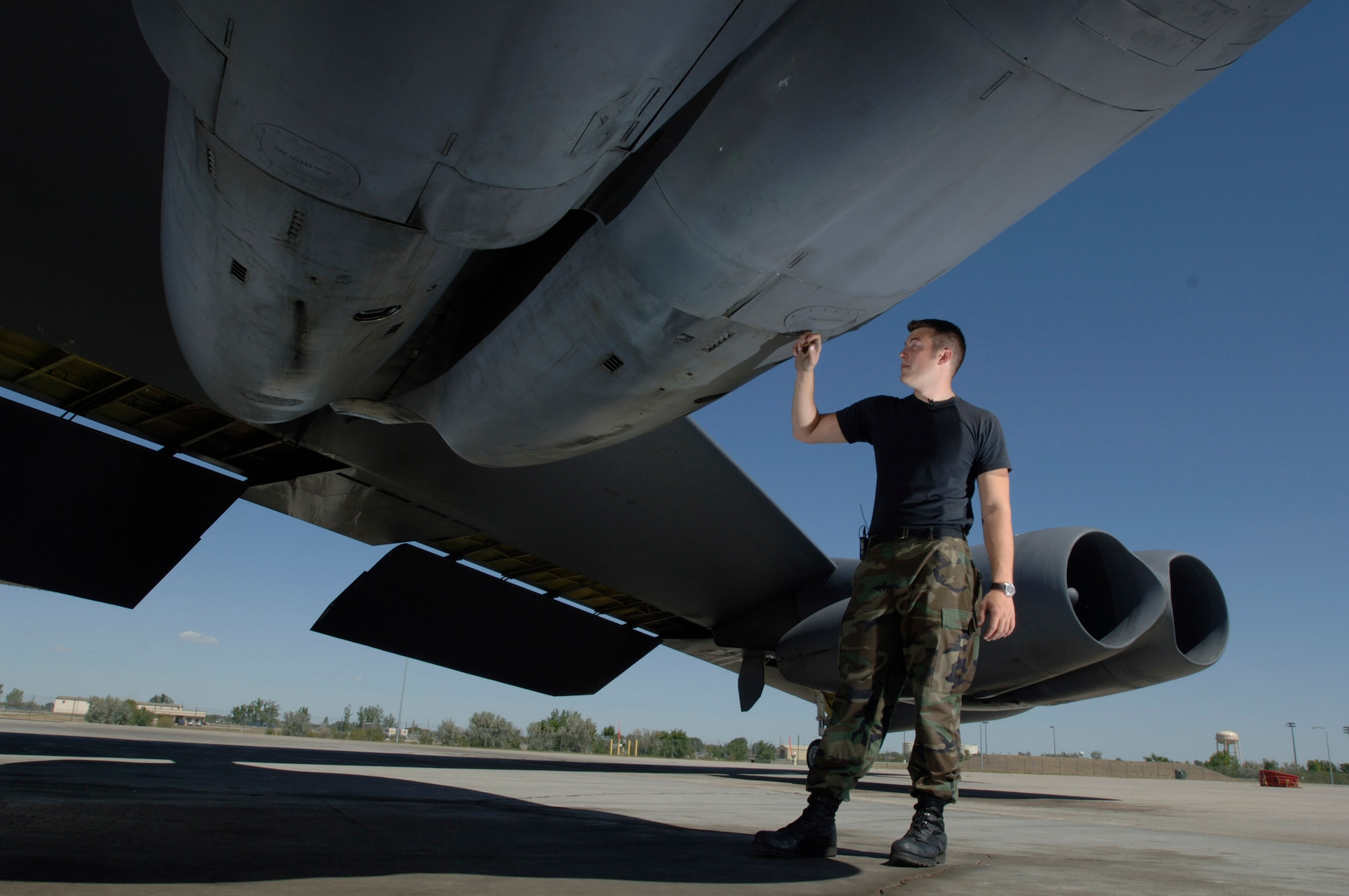 Staff Sgt. Kory McLeod inspects the cowling of engines No. 3 and 4 under the wing of a B-52 Stratofortress at Minot Air Force Base, N.D., Aug. 22. Sergeant McLeod, from Manchester, N.H., is a crew chief with the 5th Aircraft Maintenance Squadron. (U.S. Air Force photo/Master Sgt. Lance Cheung)