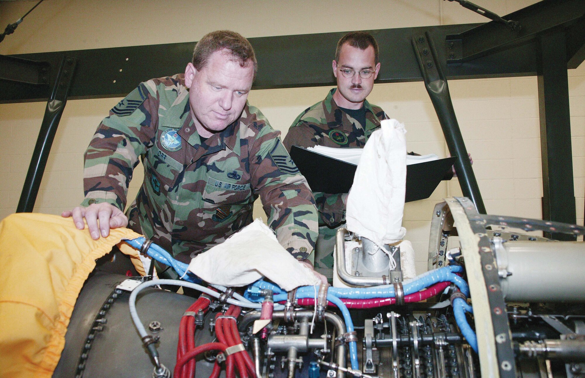 Master Sgt. Albert Orr (left) and Master Sgt. Charles Farley, both 372nd Training Squadron instructors, inspect components on an A-10 engine. These are only a few of the trained maintenance professionals the Air Force uses to weild air power. (U.S. Air Force photo/Tarsha Storey)