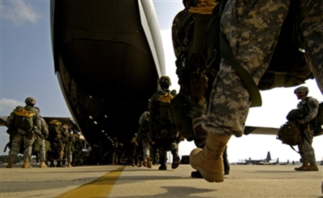 U.S. Army paratroopers board a U.S. Air Force C-17 Globemaster III aircraft at Fort Bragg, N.C., on Aug. 21, 2006.  The paratroopers will conduct an airdrop as part of Joint Forcible Entry Exercise, which is an Army and Air Force training exercise designed to validate combat readiness.  The paratroopers are attached to the Armyís 35th Signal Battalion.  