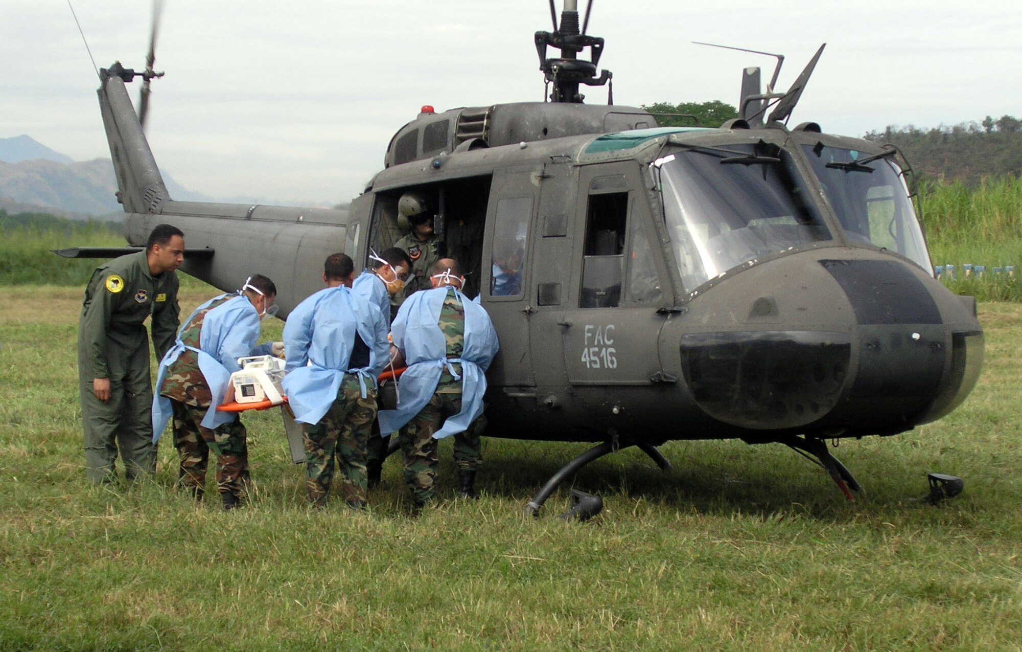 Airman 1st Class Edgardo Sanchez de Jesus instructs students on how to properly load a patient on a helicopter for transport during an International Aeromedical Evacuation Critical Care Transport Course in Colombia Aug. 15. Airman Sanchez de Jesus is a cardiopulmonary technician with the 759th Surgical Operations Squadron at Lackland Air Force Base, Texas. (U.S. Air Force photo/Master Sgt. Marcus Vigil)   