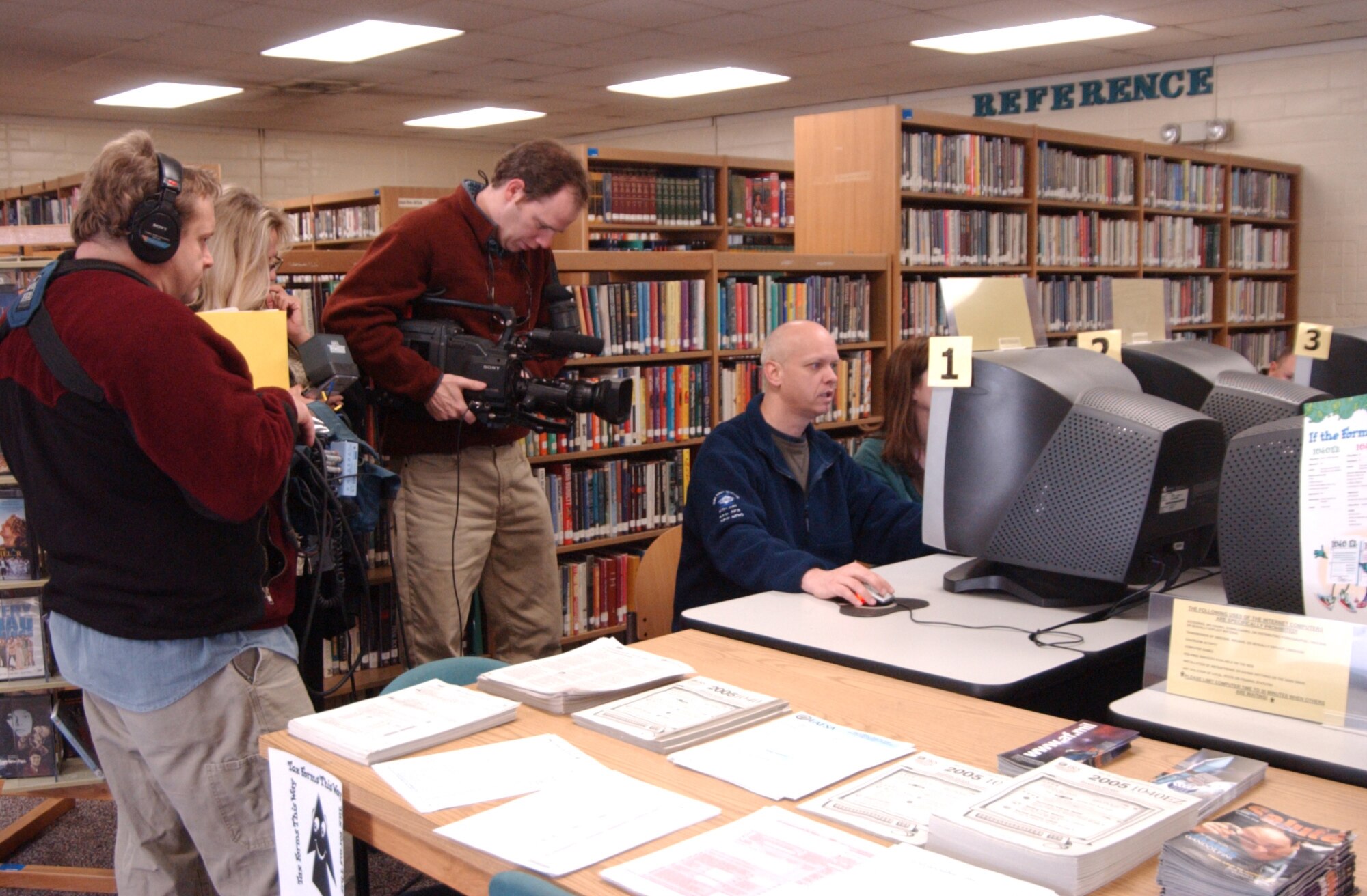 A Pie Town productions crew films Senior Master Sgt. Greg Day and wife, Diane, as they search the internet for homes for sale in the area at the Maxwell Air Force Base, Ala., library. The filming is for Home and Garden Television series House Hunters. (U.S. Air Force photo by Tech. Sgt. Scott Moorman)