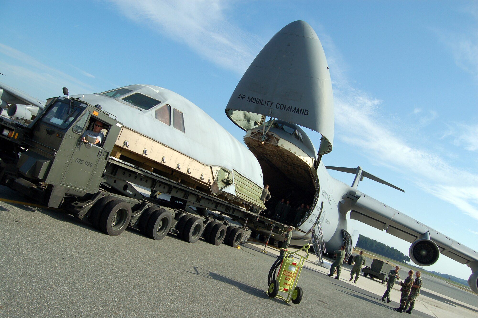 Airmen from Dover Air Force Base, Del., load a C-5 Galaxy flight deck onto another C-5 for transport to Robins Air Force Base, Ga., Aug. 22. The flight deck from the C-5 that crashed April 3 will be used as a simulator to help train and test aircrews. (U.S. Air Force photo/Airman 1st Class James Bolinger)

