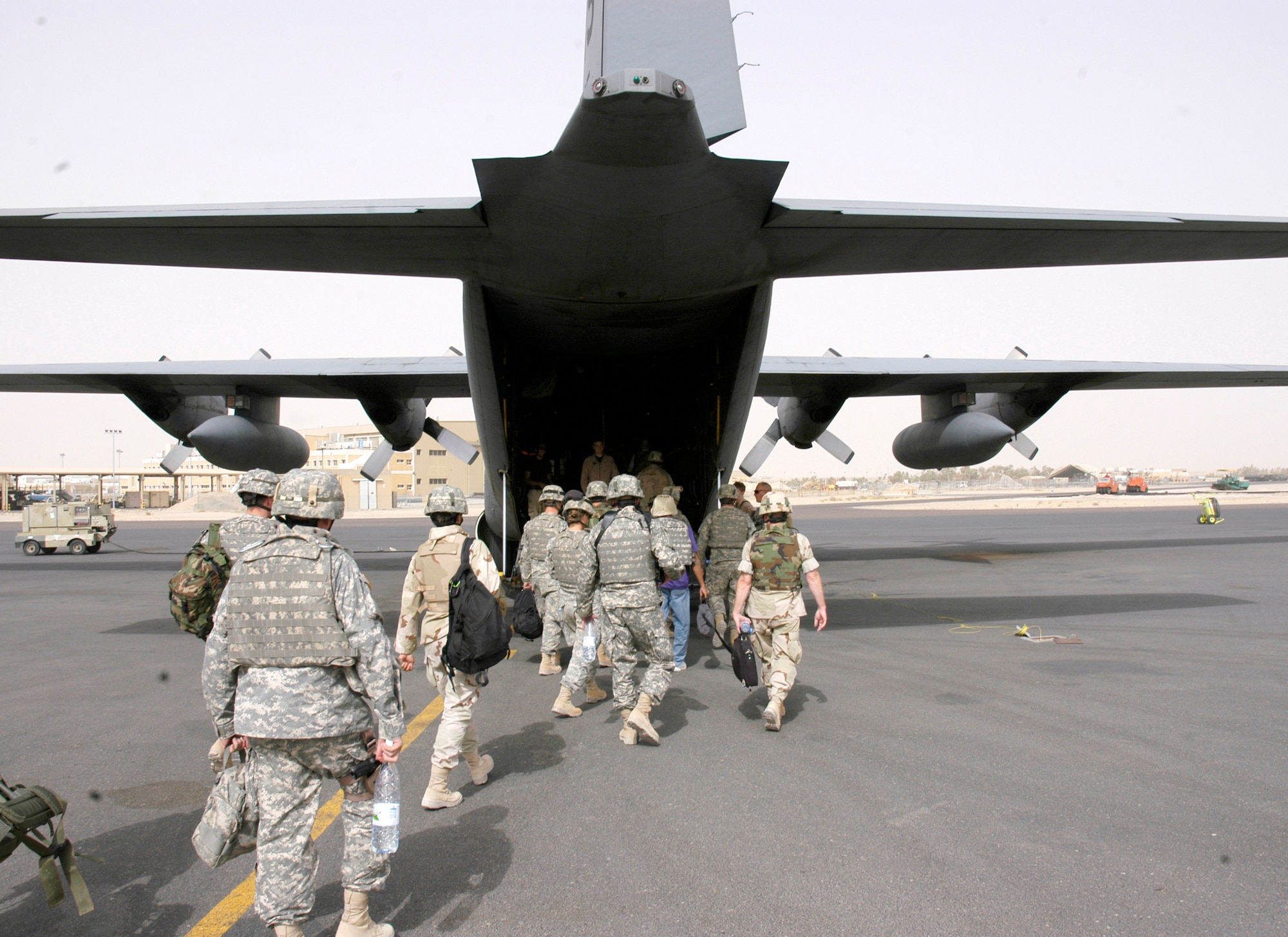 Servicemembers and civilians board a C-130 Hercules heading to Iraq from the home of the 386th Air Expeditionary Wing in Southwest Asia. The 386th AEW is the primary aerial hub for Operation Iraqi Freedom and provides airlift support for Operation Enduring Freedom and the Horn of Africa. The 386th AEW is composed of more than 3,400 Airmen from the National Guard, Air Force Reserve and active duty. (U.S. Air Force photo/Staff Sgt. Ryan Hansen) 
