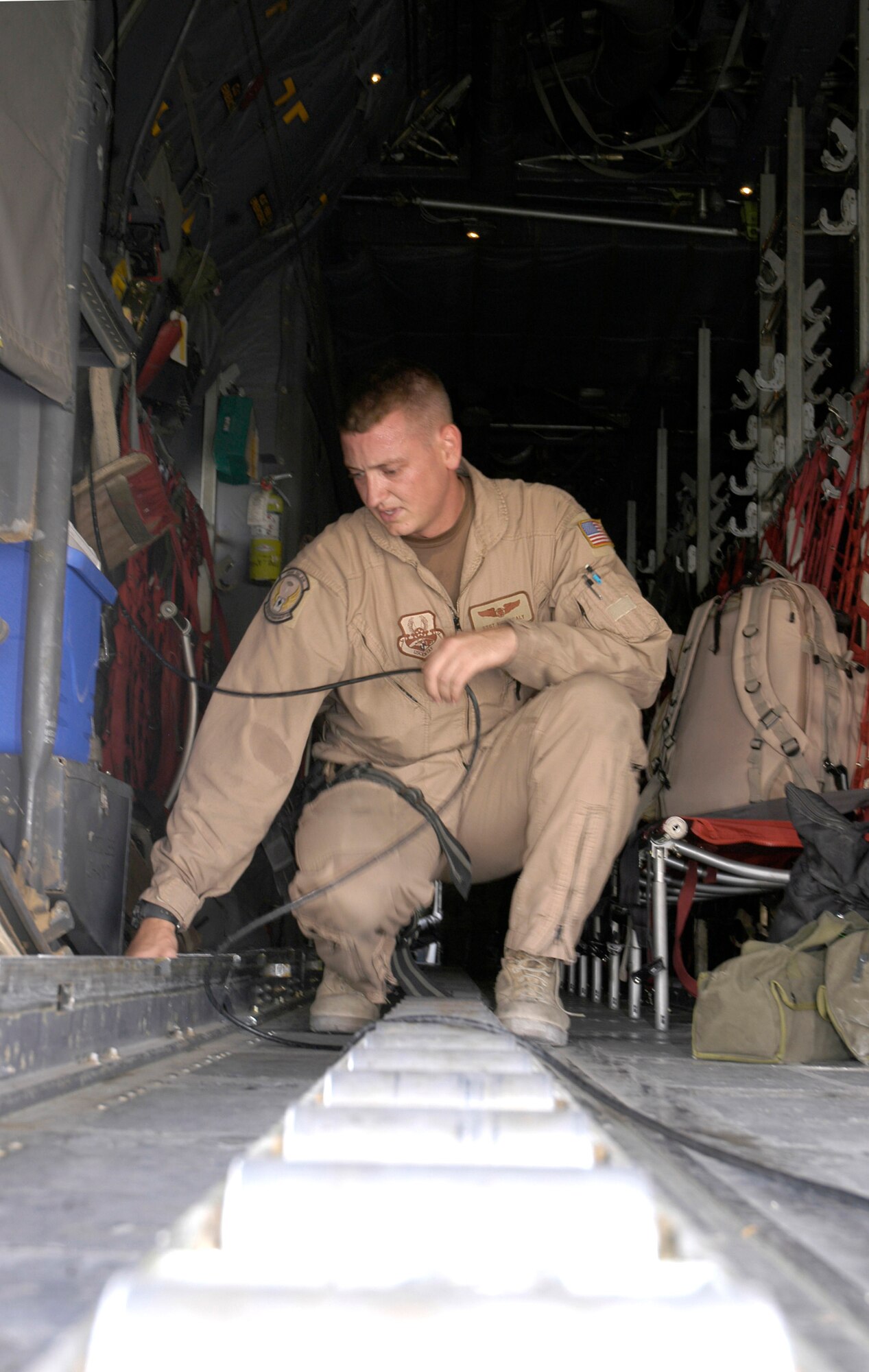 Staff Sgt. Nick Sealy configures a C-130 Hercules in preparation for passengers and cargo at a forward operating base in Southwest Asia Aug. 23. Sergeant Sealy is a loadmaster with the 738th Expeditionary Airlift Squadron, which is part of the 386th Air Expeditionary Wing. The wing is the primary aerial hub for Operation Iraqi Freedom and provides airlift support for Operation Enduring Freedom and the Horn of Africa. (U.S. Air Force photo by Staff Sgt. Ryan Hansen)
