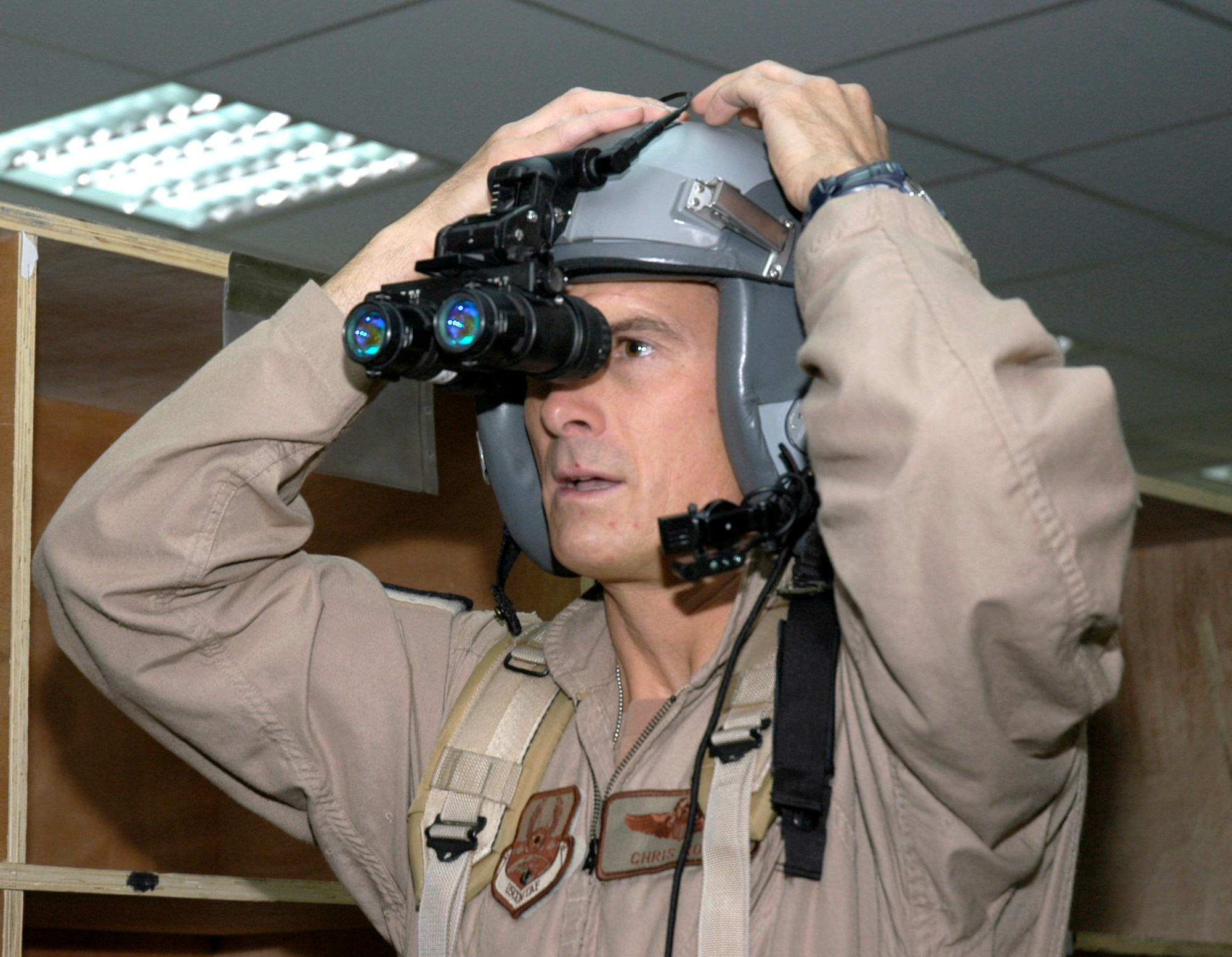 Lt. Col. Chris Goff checks his night-vision goggles at a forward operating base in Southwest Asia Aug. 23. Colonel Goff is an aircraft commander and director of operations for the 738th Expeditionary Airlift Squadron, which is part of the 386th Air Expeditionary Wing. The wing is the primary aerial hub for Operation Iraqi Freedom and provides airlift support for Operation Enduring Freedom and the Horn of Africa. (U.S. Air Force photo/Staff Sgt. Ryan Hansen) 
