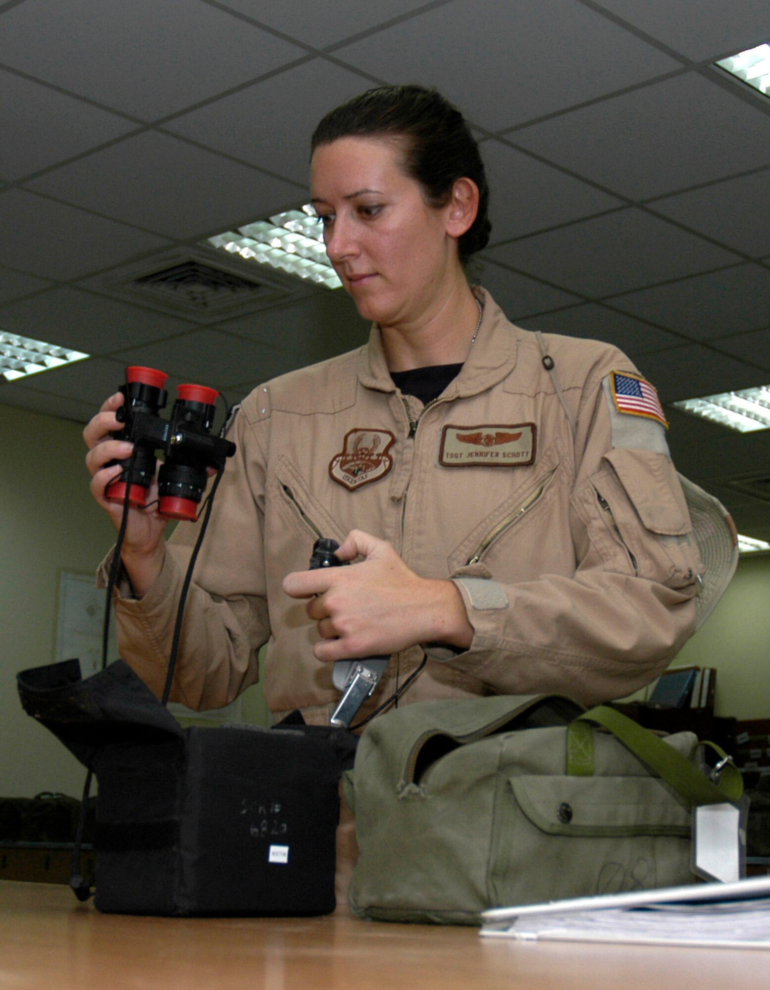 Tech. Sgt. Jennifer Schott checks her night-vision goggles at a forward operating base in Southwest Asia Aug. 23. Sergeant Schott is a loadmaster with the 738th Expeditionary Airlift Squadron, which is part of the 386th Air Expeditionary Wing. The wing is the primary aerial hub for Operation Iraqi Freedom and provides airlift support for Operation Enduring Freedom and the Horn of Africa. (U.S. Air Force photo/Staff Sgt. Ryan Hansen)
